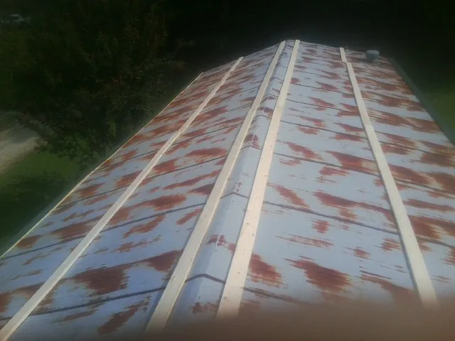 Rusted metal roof panels with new wood purlins before replacement — Storm Damage Roof Repair in Horsham by Roofing Brothers