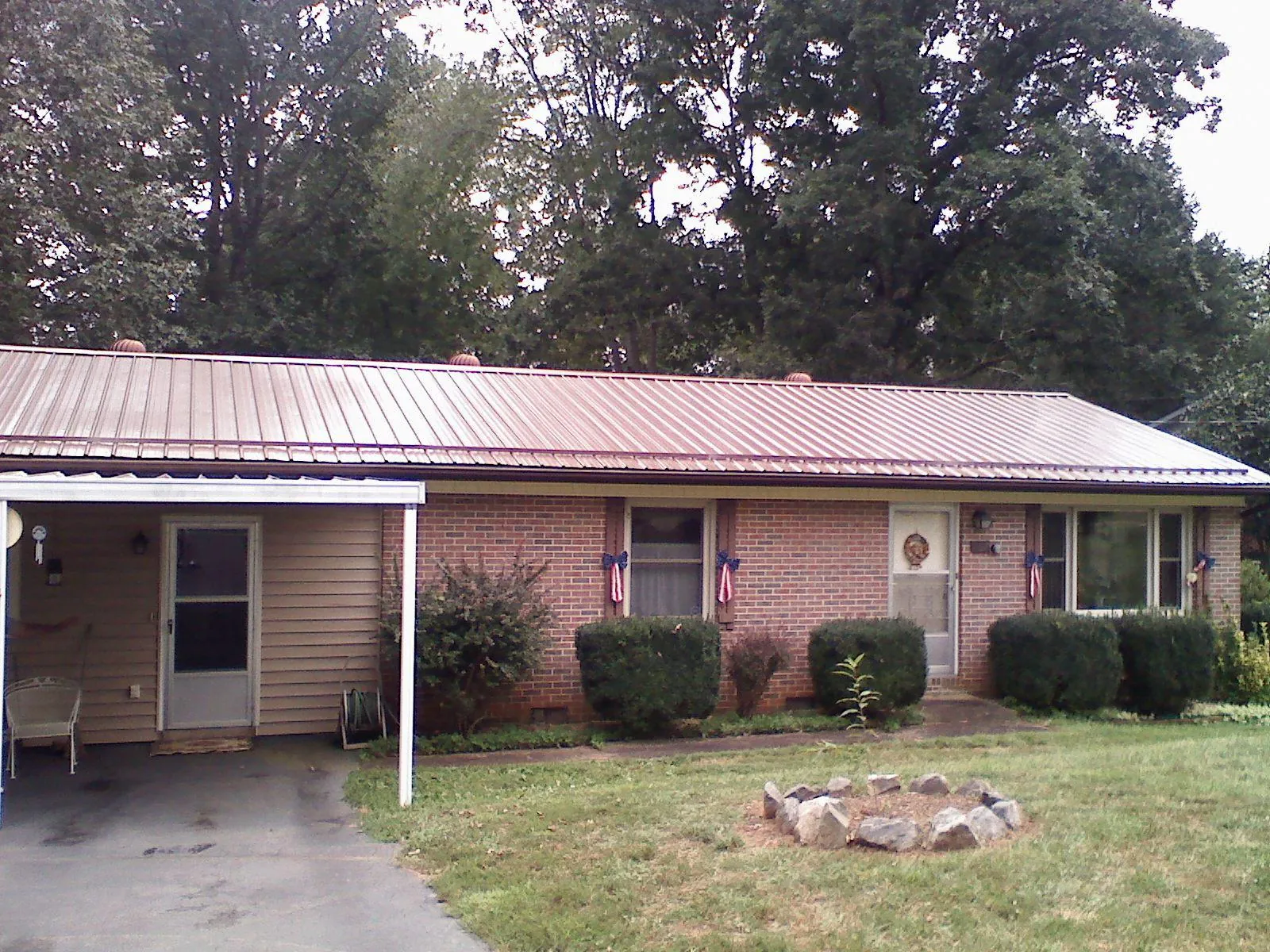 Bronze metal roof and carport on a brick ranch home — Roof Repair work by our crew in Horsham